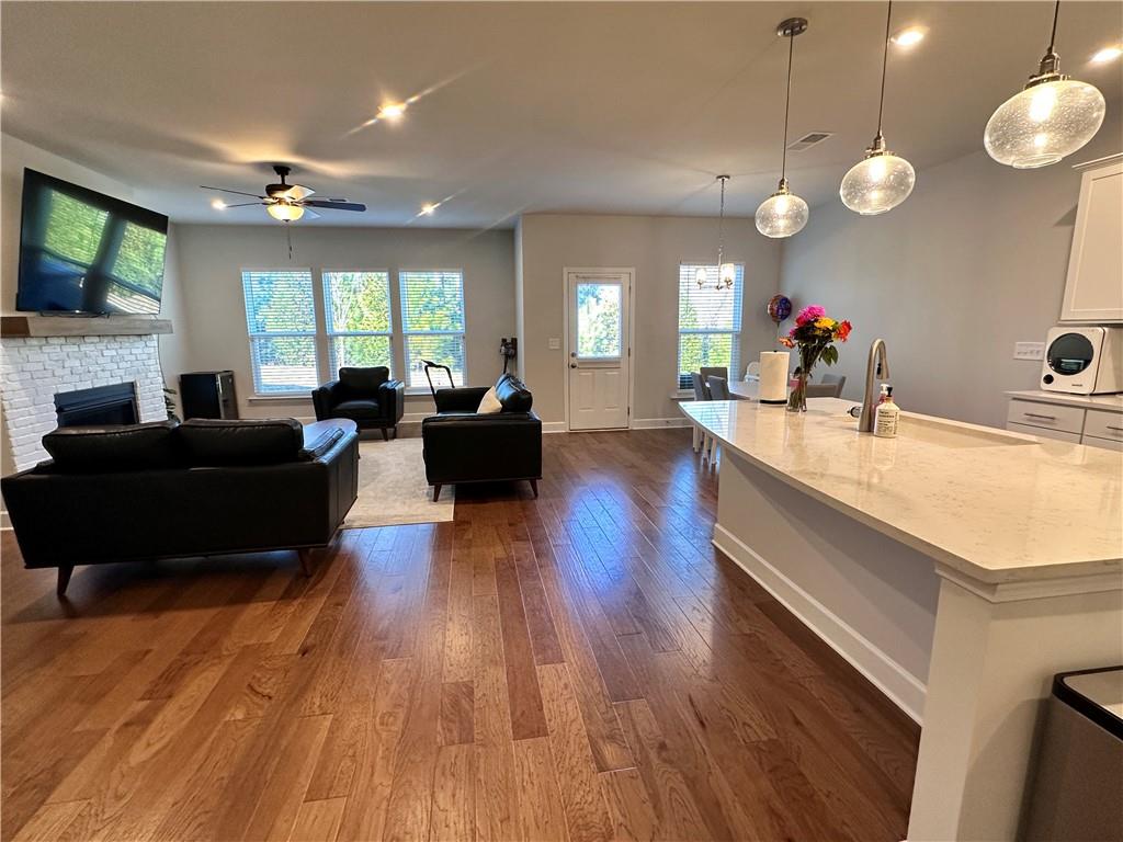 5430 Wheeler Ridge Road Auburn, GA 30011 - Photo 12 of 32 a living room with couches a flat tv screen and a dishwasher with kitchen view