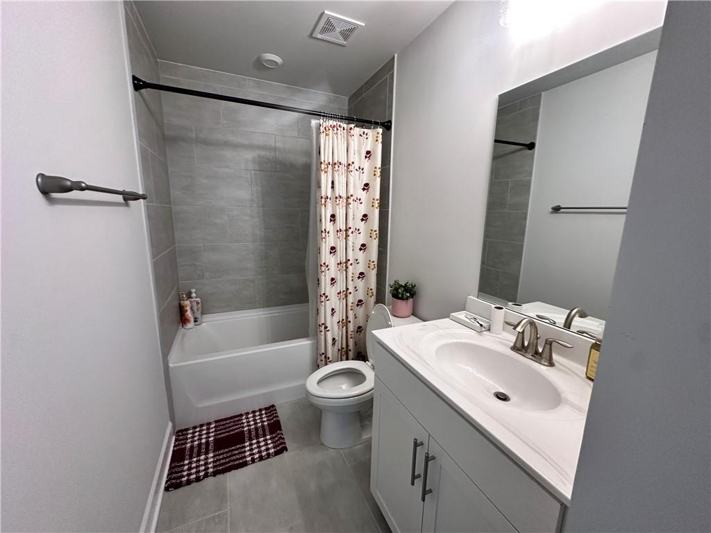 5430 Wheeler Ridge Road Auburn, GA 30011 - Photo 18 of 32 a bathroom with a sink toilet and shower