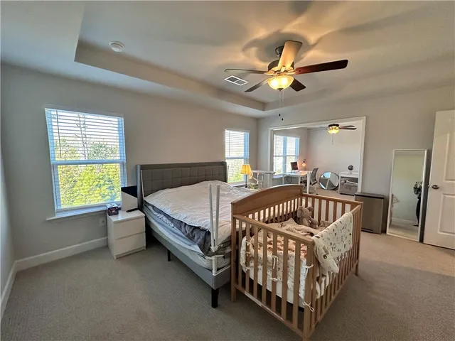 a bedroom with a bed and a chandelier