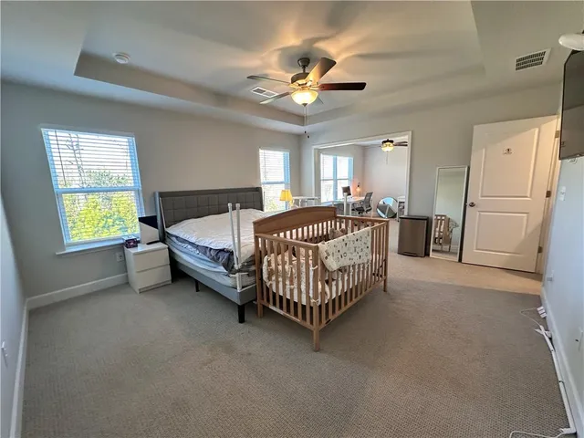 a bed room with a bed and a chandelier