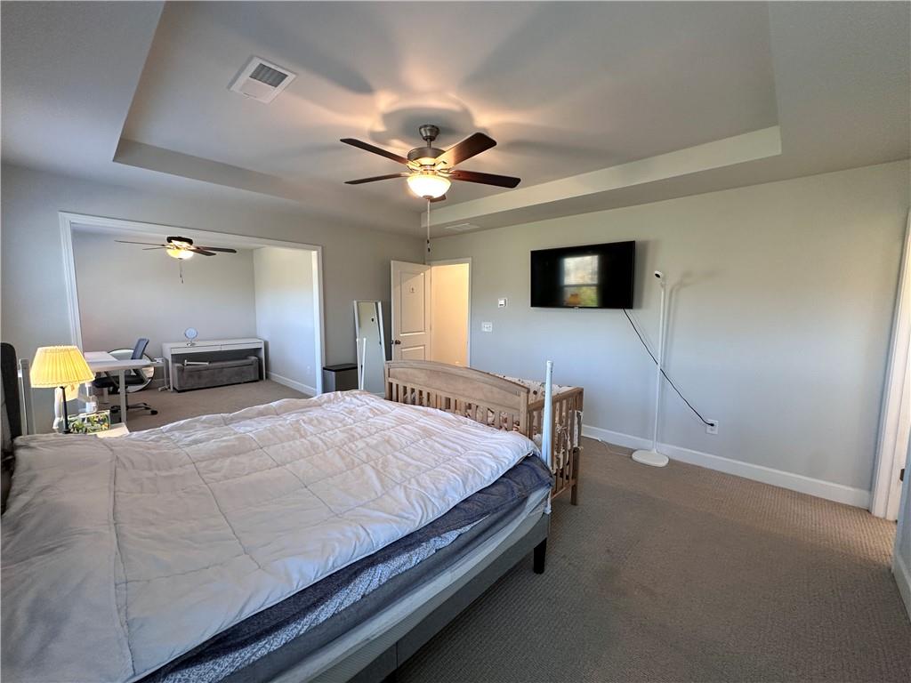 5430 Wheeler Ridge Road Auburn, GA 30011 - Photo 30 of 32 a bedroom with a bed and a flat tv screen on dresser