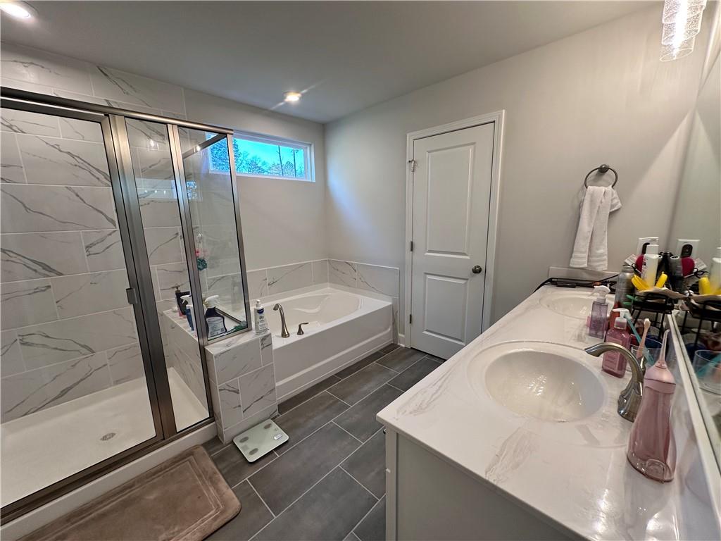 5430 Wheeler Ridge Road Auburn, GA 30011 - Photo 32 of 32 a bathroom with a tub sink and mirror