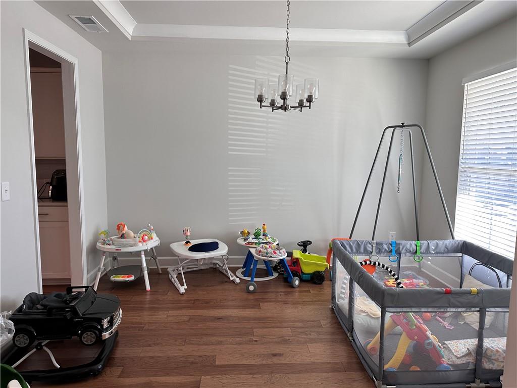 5430 Wheeler Ridge Road Auburn, GA 30011 - Photo 4 of 32 a view of a workspace with furniture and a wooden floor