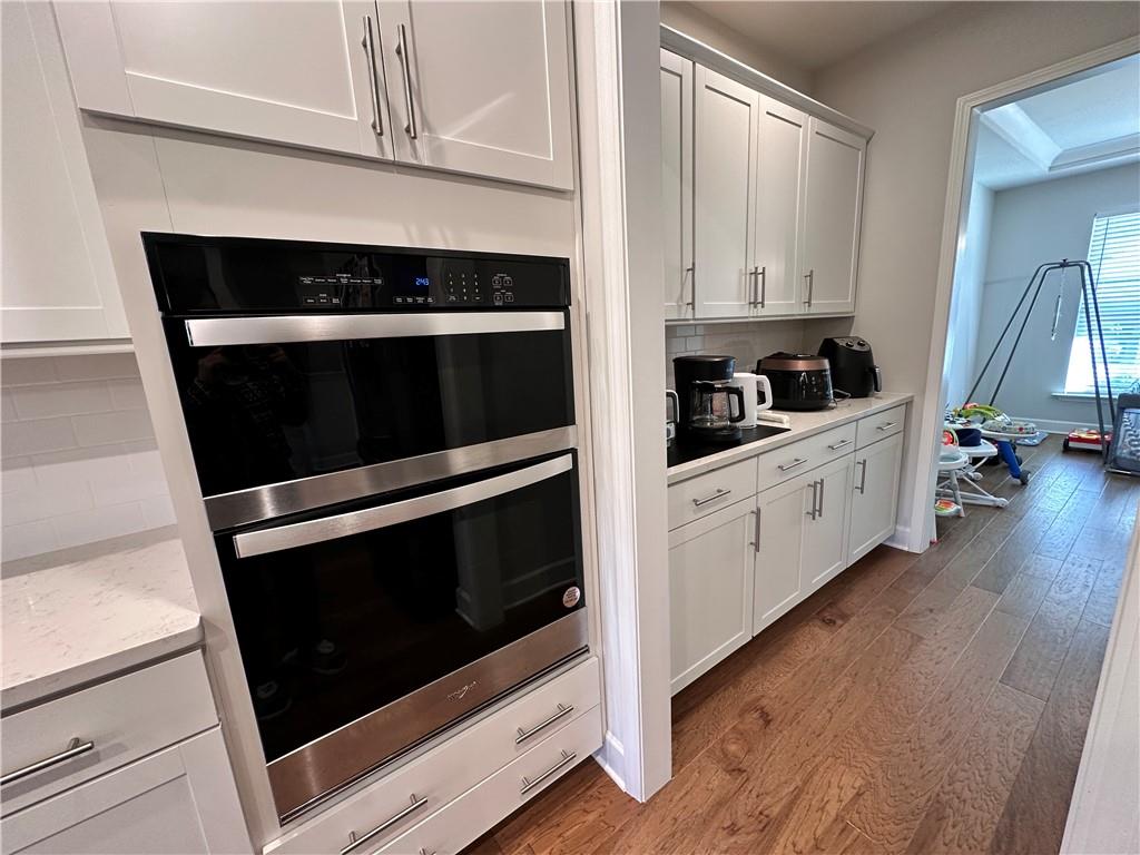 5430 Wheeler Ridge Road Auburn, GA 30011 - Photo 9 of 32 a kitchen with granite countertop white cabinets and appliances
