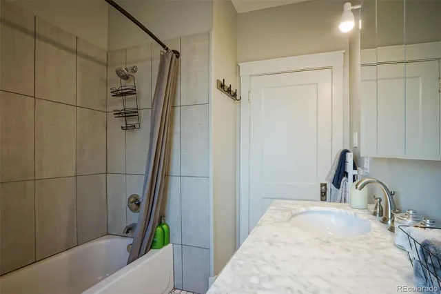 a bathroom with a tub and a sink