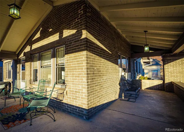 a blue and white sitting area in front of a house