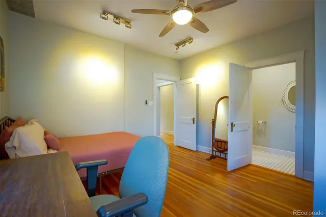 a view of a bedroom with wooden floor