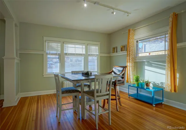 a view of a dining room with furniture and wooden floor