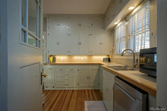 a kitchen with cabinets a sink and appliances
