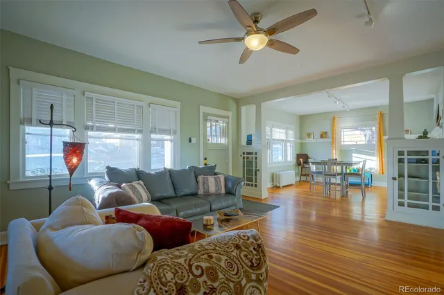 a living room with furniture and a wooden floor