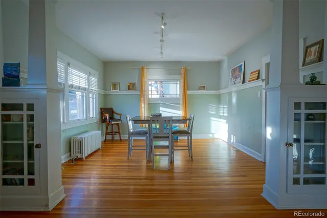 a view of a dining room with furniture window and wooden floor