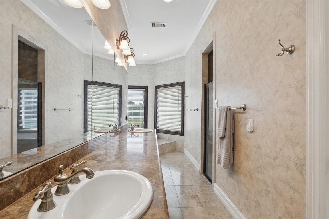 90 Greenview Street Montgomery, TX 77356 - Photo 15 of 34 a bathroom with a sink double vanity and shower