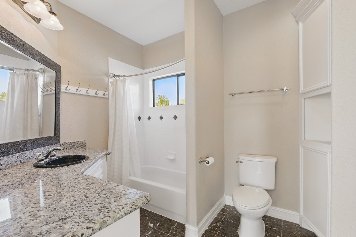 90 Greenview Street Montgomery, TX 77356 - Photo 21 of 34 a bathroom with a granite countertop sink toilet and shower