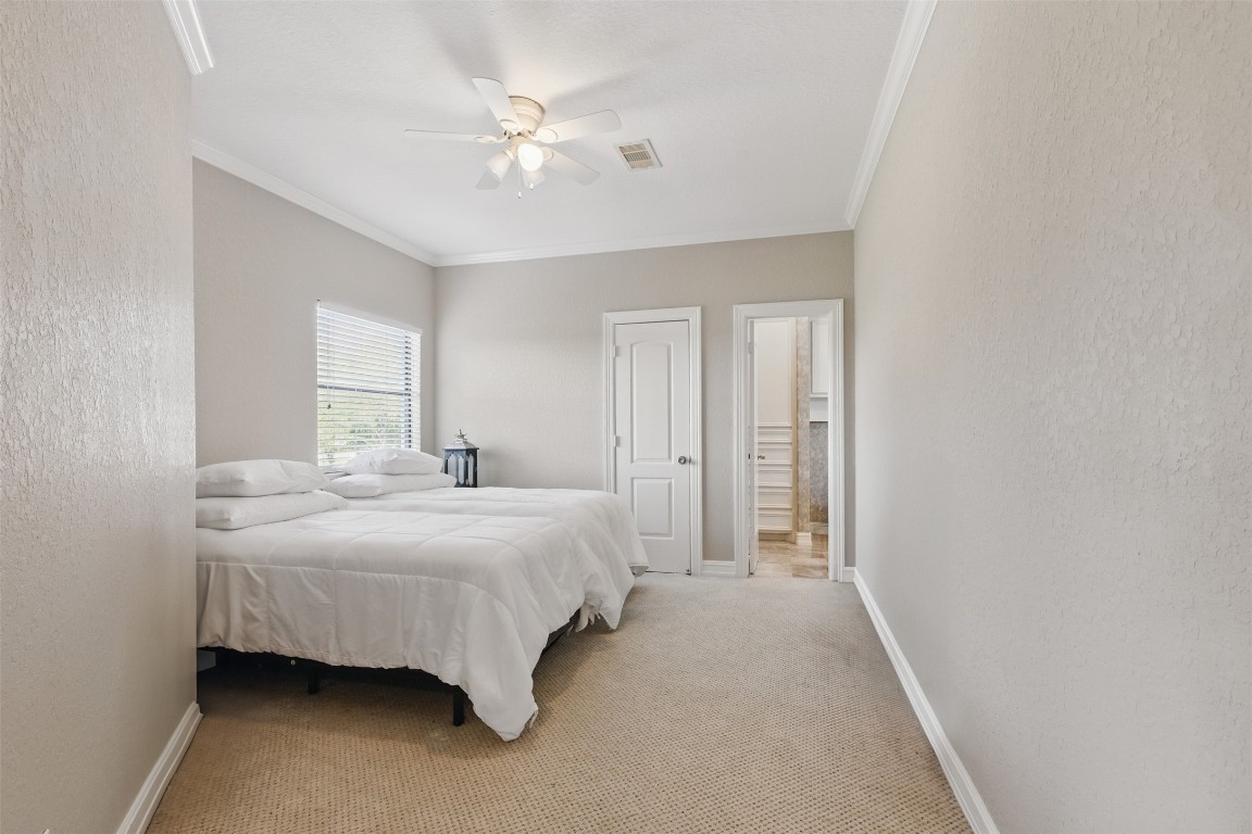 90 Greenview Street Montgomery, TX 77356 - Photo 23 of 34 a bedroom with a bed and a chandelier
