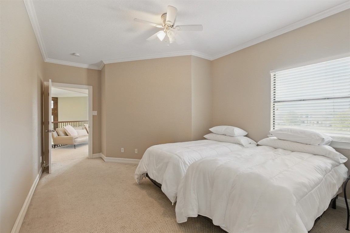 90 Greenview Street Montgomery, TX 77356 - Photo 24 of 34 a bedroom with a bed and a chandelier