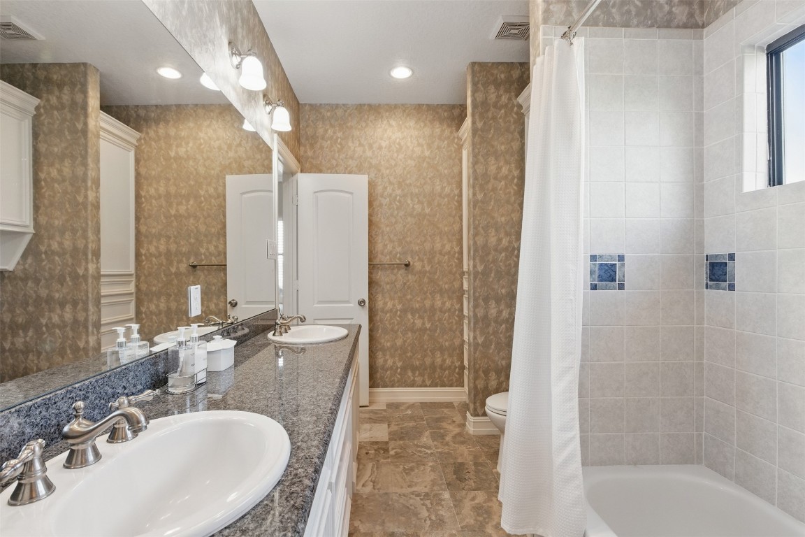 90 Greenview Street Montgomery, TX 77356 - Photo 26 of 34 a bathroom with a sink a toilet a shower and a mirror