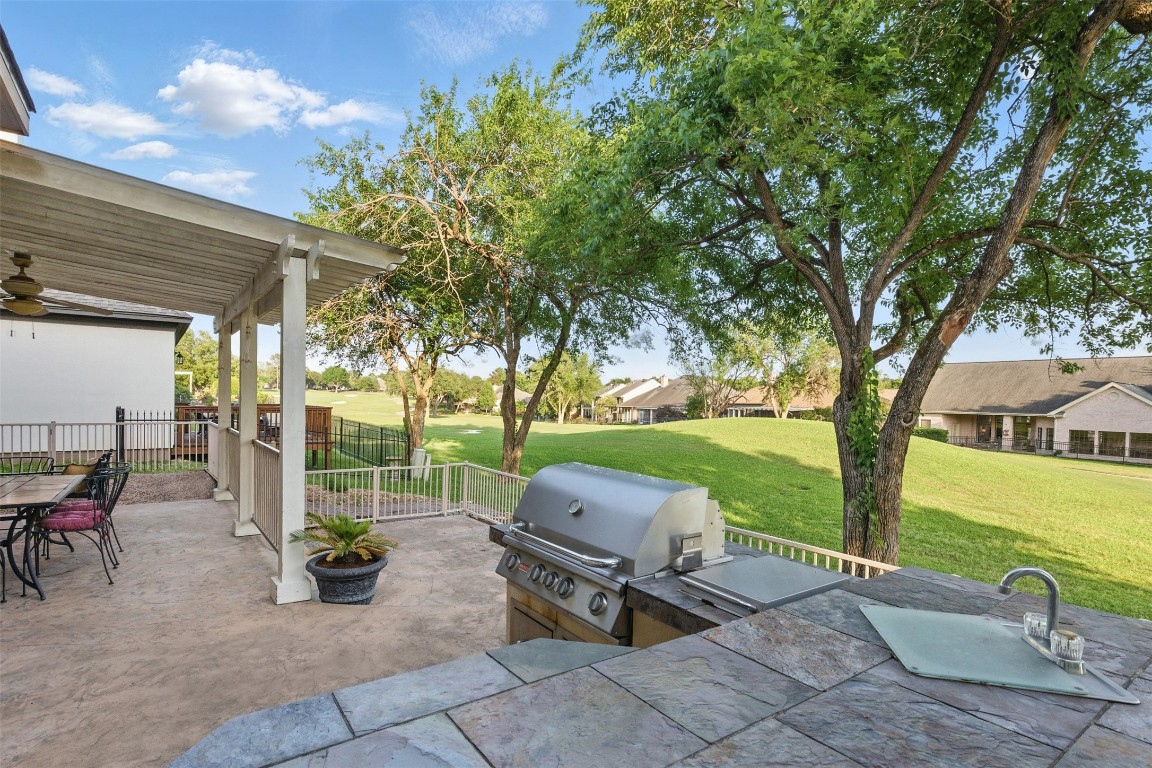 90 Greenview Street Montgomery, TX 77356 - Photo 31 of 34 a view of a patio with table and chairs potted plants and a large tree