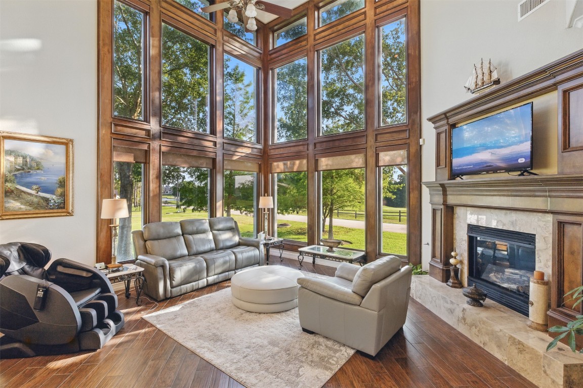 90 Greenview Street Montgomery, TX 77356 - Photo 4 of 34 a living room with furniture a fireplace and floor to ceiling windows