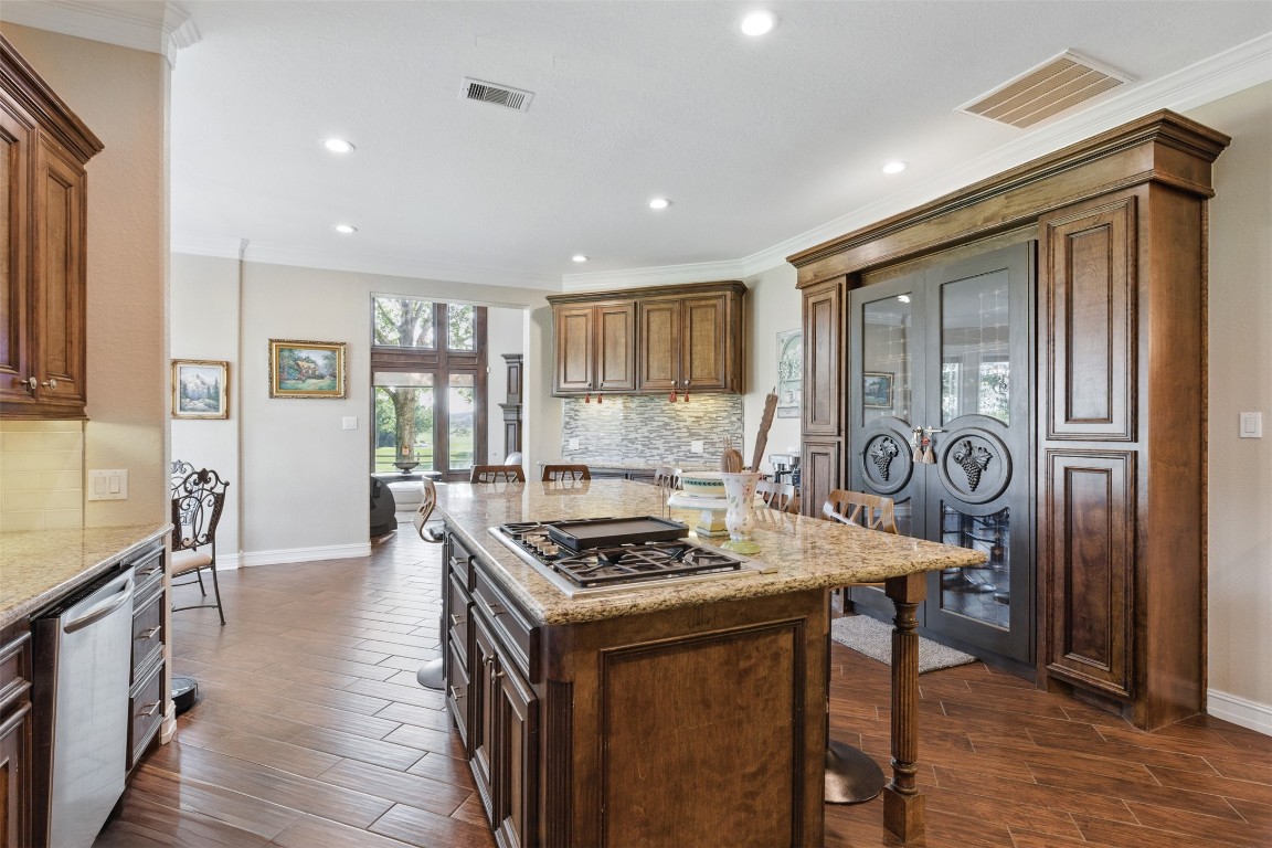 90 Greenview Street Montgomery, TX 77356 - Photo 10 of 34 a kitchen with stainless steel appliances granite countertop a stove top oven a sink and a refrigerator