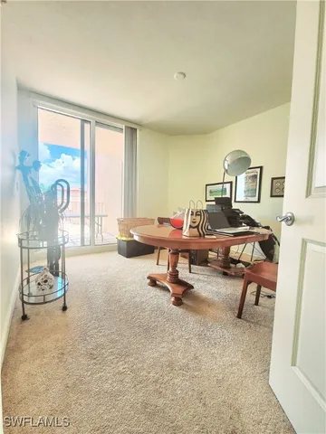 a view of a livingroom with workspace and a window