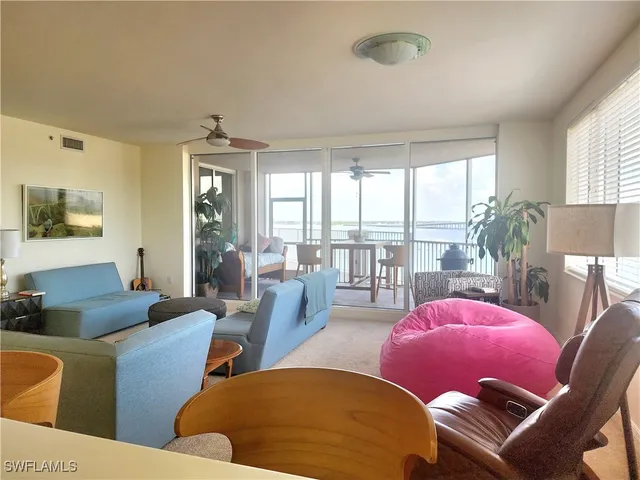 a living room with furniture and a floor to ceiling window