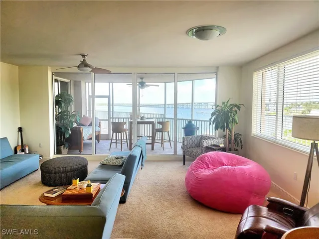 a living room with furniture and a floor to ceiling window