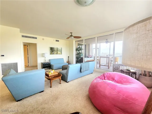 a living room with furniture and large windows