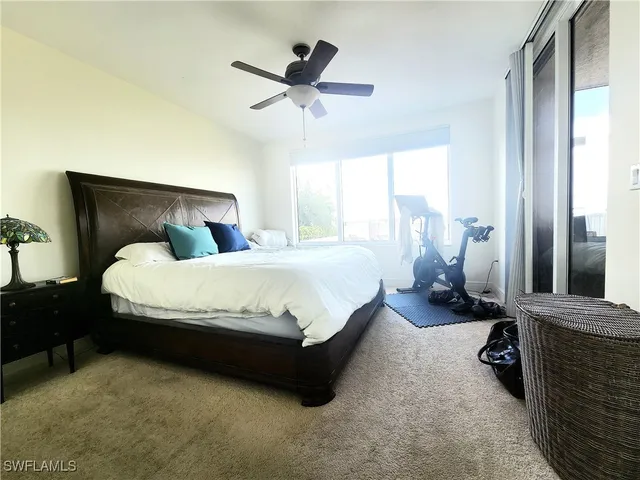 a large bed sitting in a room next to a window
