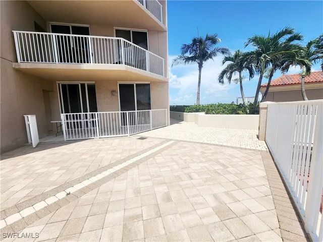 a view of a house with a wooden deck