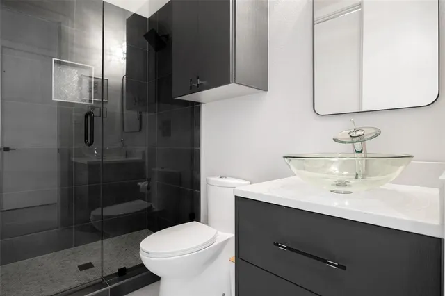 a bathroom with a sink toilet and shower