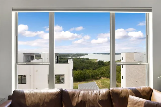 a living room with furniture a floor to ceiling window