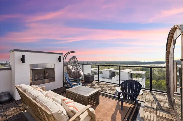 a view of balcony with furniture and fireplace