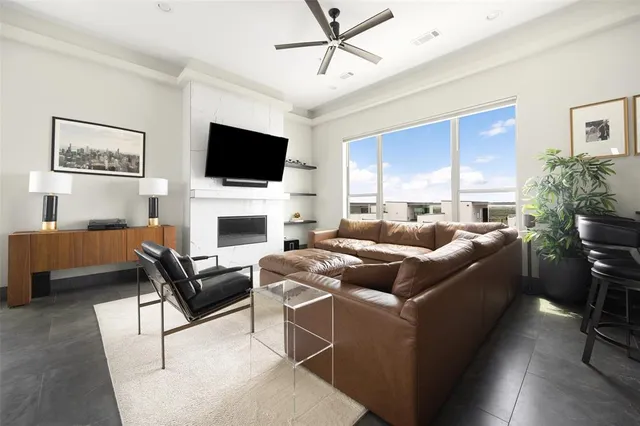 a living room with furniture a flat screen tv and a fireplace