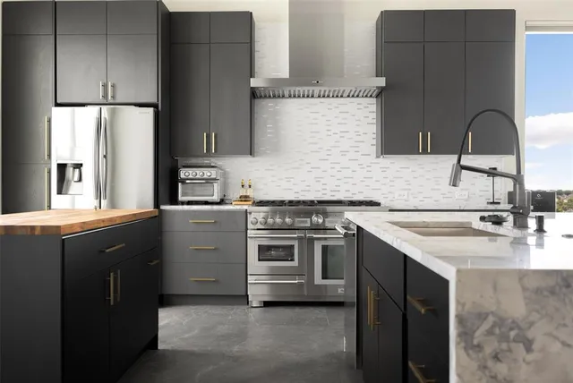 a kitchen with a sink stove and cabinets