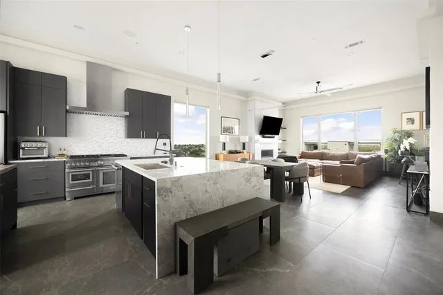 a large white kitchen with a large window and a sink