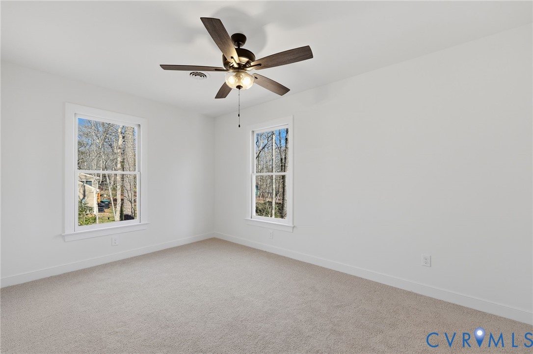 3264 Sherwood Ridge Way Powhatan, VA 23139 - Photo 24 of 40 an empty room with windows and fan