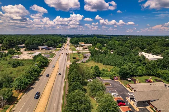 a view of a city with lots of trees and houses in the background
