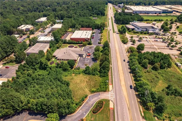 an aerial view of a house with a yard and lake view