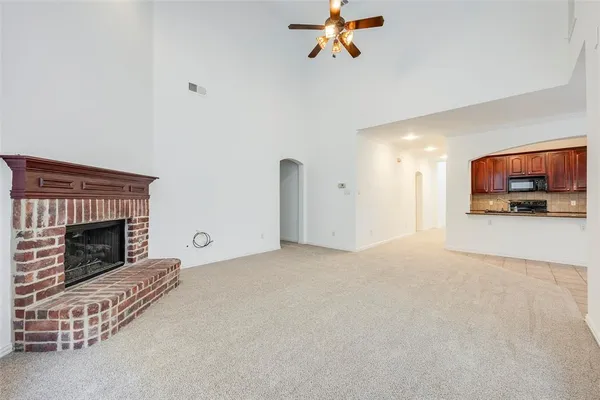 a view of a livingroom with a fireplace and a chandelier