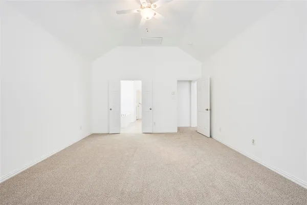 an empty room with a ceiling fan and a window