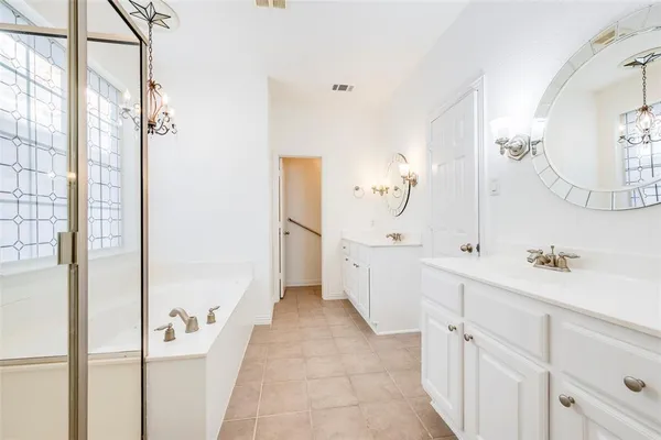 a bathroom with a double vanity sink and mirror