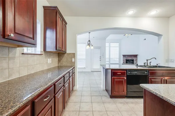 a kitchen with stainless steel appliances granite countertop a sink and cabinets