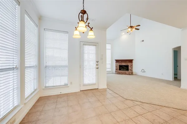 a view of a livingroom with a chandelier fireplace and a window