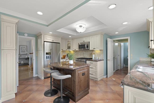 122 Jaybee Place San Jose, CA 95123 - Photo 14 of 40 a kitchen with stainless steel appliances kitchen island granite countertop a refrigerator and a stove top oven