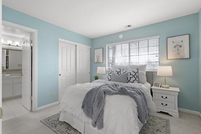 122 Jaybee Place San Jose, CA 95123 - Photo 23 of 40 a spacious bedroom with a bed and a window