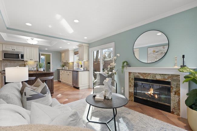 122 Jaybee Place San Jose, CA 95123 - Photo 9 of 40 a living room with furniture a fireplace a rug and kitchen view