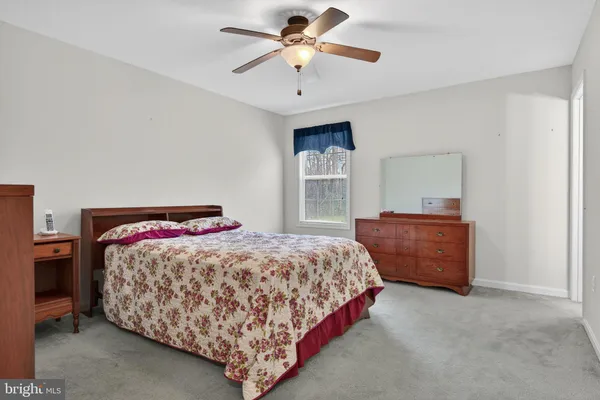 a bedroom with a bed and a dresser