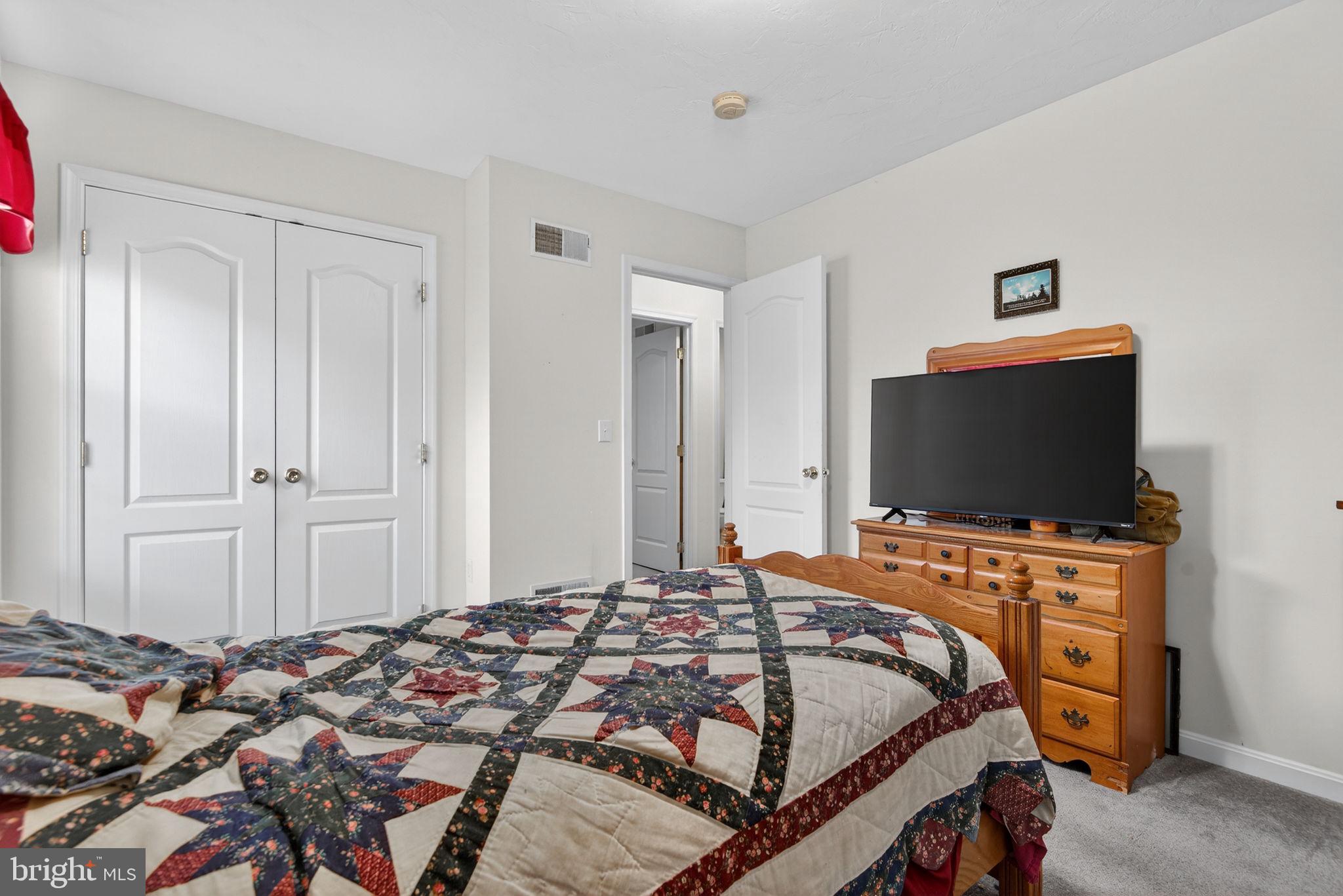 213 Maple Drive Hanover, PA 17331 - Photo 20 of 24 a bedroom with a bed and a flat screen tv