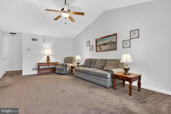 a living room with furniture and a lamp