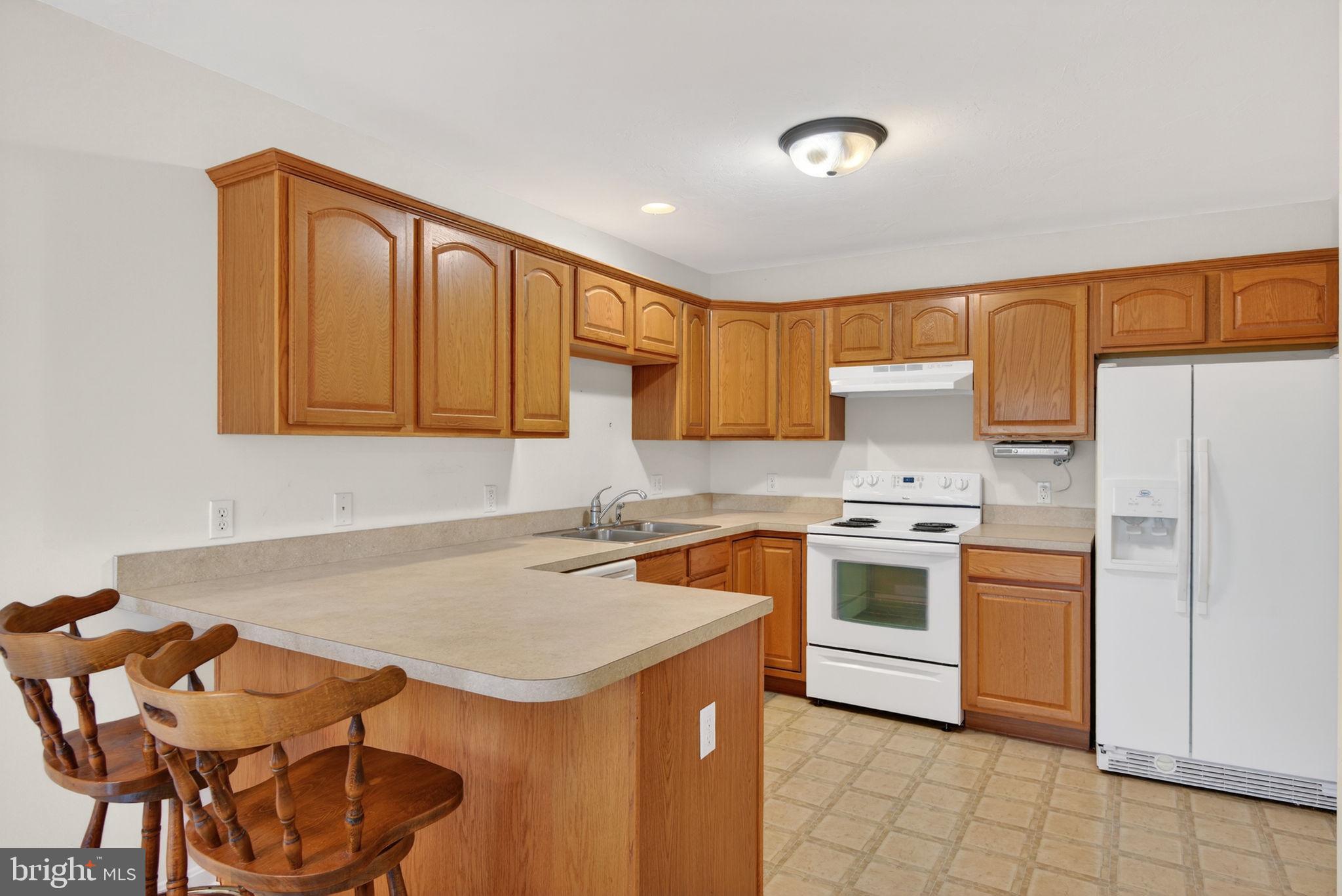 213 Maple Drive Hanover, PA 17331 - Photo 9 of 24 a kitchen with stainless steel appliances granite countertop a stove a sink dishwasher and a refrigerator